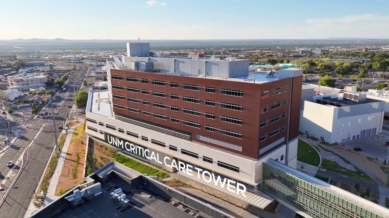 Drone orbit of the UNM Hospital Critical Care Tower, then a wide view with the Sandia Mountains